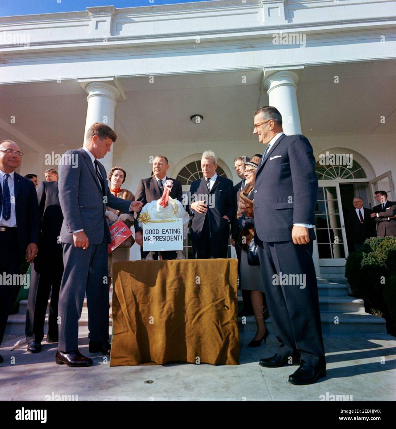 Presentation of a Thanksgiving Turkey to President Kennedy, 10:00AM. President John F. Kennedy receives a turkey presented to him for Thanksgiving by the National Turkey Federation and the Poultry and Egg National Board; President Kennedy pardoned the turkey. Left to right: Vice President of the National Turkey Federation, Morris G. Smith; Administrative Assistant to the President, Mike Manatos (partially hidden); two unidentified persons; President Kennedy; Mrs. Robert M. McPherrin; President of the National Turkey Federation, Robert M. McPherrin; Senator Everett Dirksen (Illinois); Executive Stock Photo
