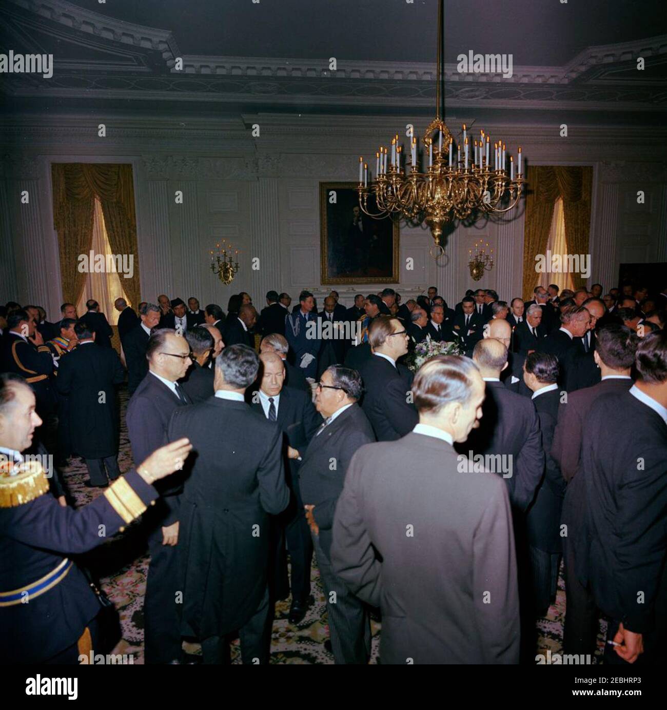 State Funeral of President Kennedy: White House, post funeral Reception. Guests attend a reception at the White House, following the state funeral of President John F. Kennedy. Those pictured include: Minister of Foreign Affairs of France, Maurice Couve de Murville; Minister of Foreign Affairs of Pakistan, Zulfikar Ali Bhutto; Minister of Foreign Affairs of Argentina, Dr. Miguel u00c1ngel Zavala Ortiz; Ambassador of Great Britain, Sir David Ormsby-Gore; Naval Aide to President Kennedy, Captain Tazewell Shepard; Julia Ann Shepard; Minister of Foreign Affairs of Panama, Galileo Solis; Prince Gh Stock Photo