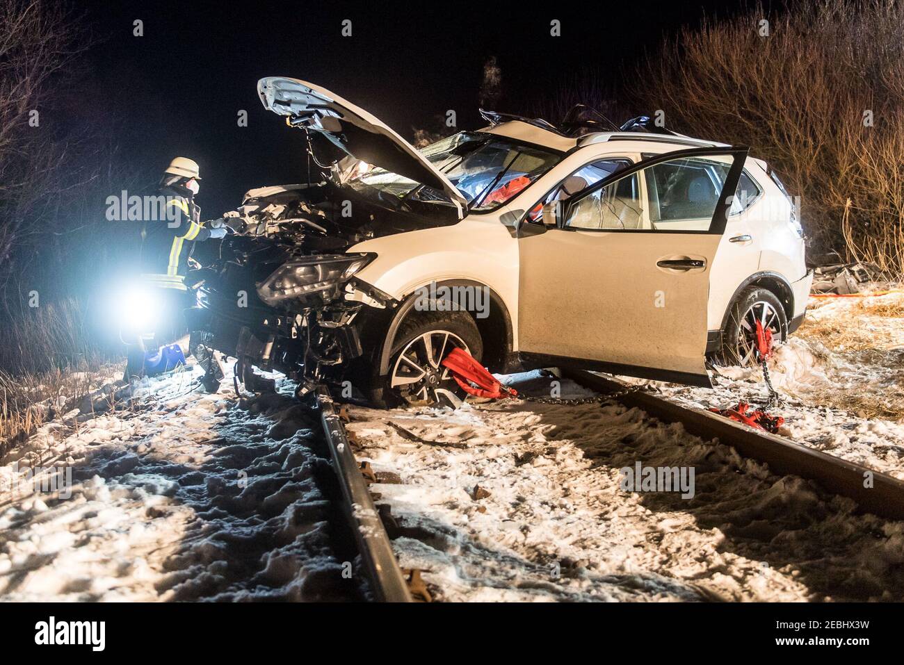 12 February 2021, Schleswig-Holstein, Dagebüll: A car lies smashed on the tracks. While attempting to cross a level crossing without a barrier and secured with flashing lights, the driver overlooked a regional train that was on its way from Niebüll to Dagebüll. The alarmed rescue forces could only determine the death of the two occupants of the car. According to the police, the 7 occupants of the train were uninjured. The driver of the railcar suffered a shock. Photo: Benjamin Nolte/dpa Stock Photo