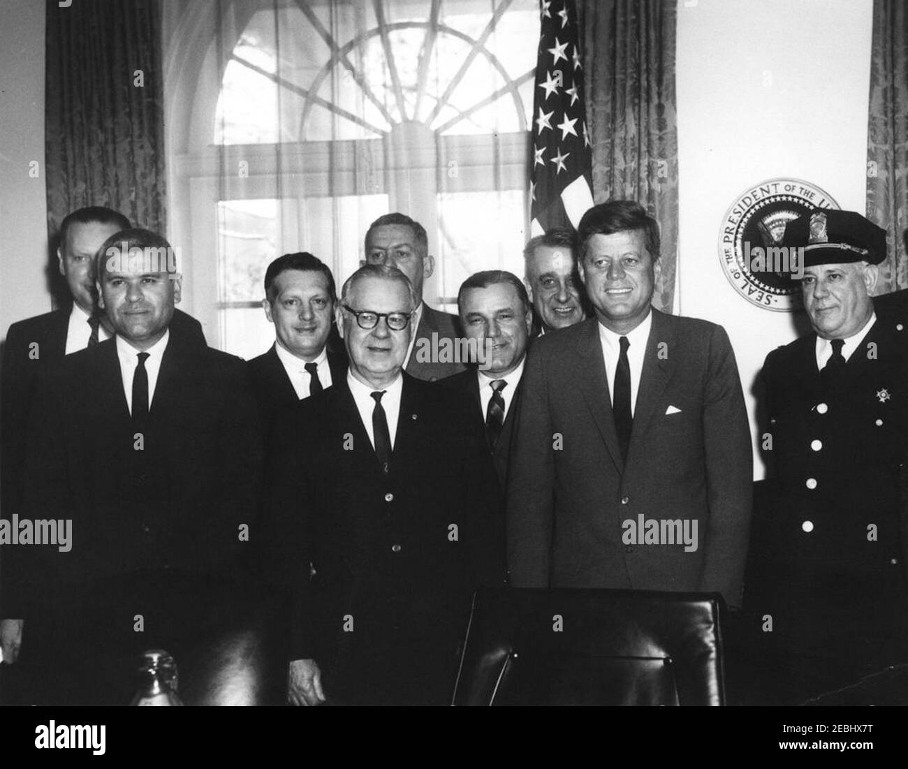 Visit of police officers to mark National Police Week, 12:53PM. President John F. Kennedy visits with police officers to mark the first annual National Police Week. Left to right: Lieutenant Thomas Herlihy, of the Metropolitan Washington Police Department (in back); acting Director of the United States Park Police, Nash Castro; unidentified (in back); President of the International Association of Chiefs of Police (IACP), Frank A. Sweeney; unidentified (behind Mr. Sweeney); unidentified; Secretary-treasurer of the National Conference of Police Associations, Royce L. Givens (in back); President Stock Photo