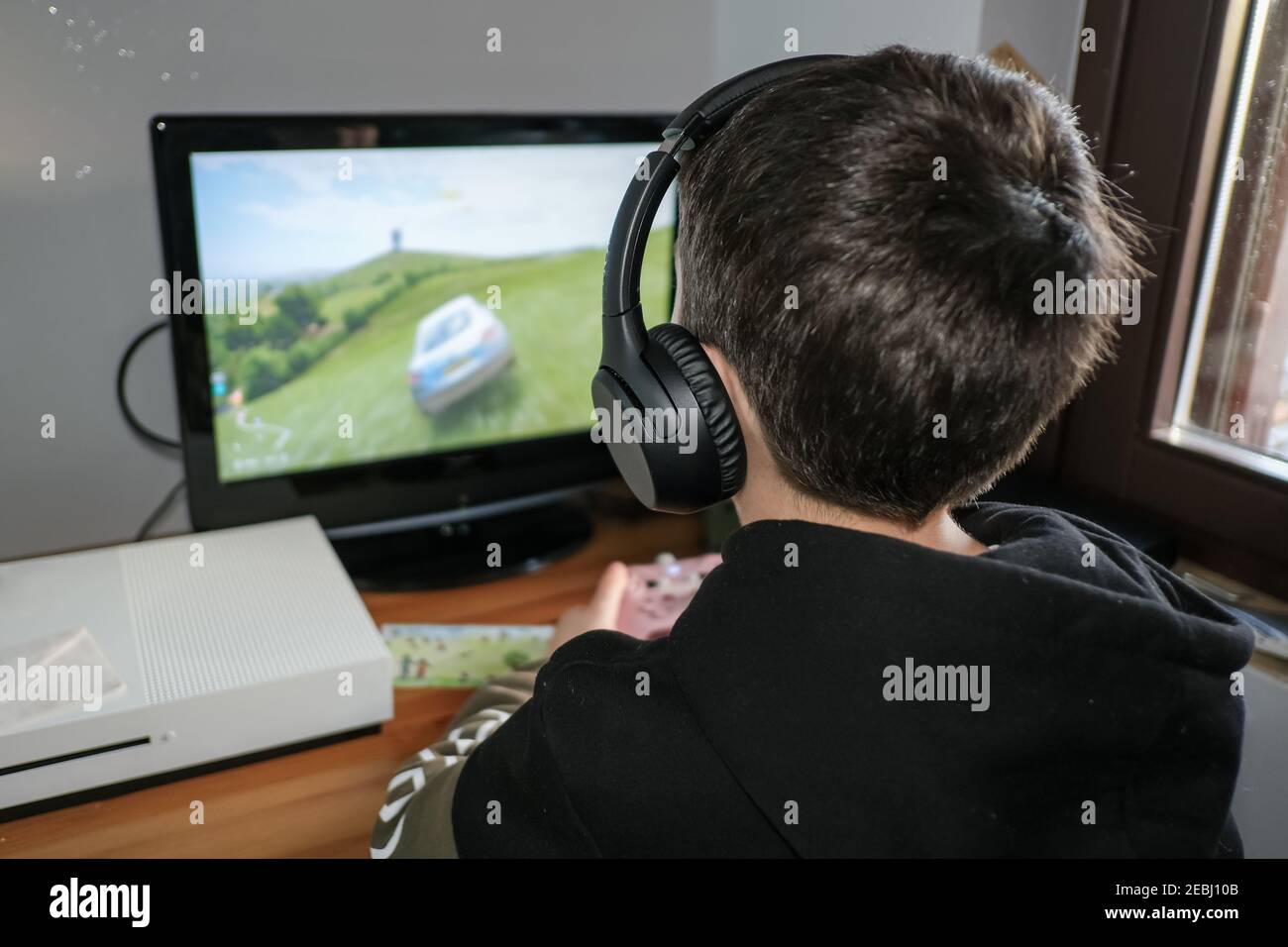 Child boy playing console game on console at home,kids videogames addiction Stock Photo