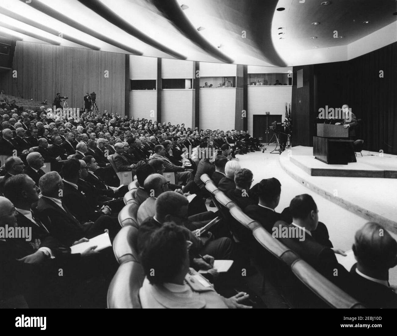 Address to the White House Conference of Business Magazine Editors and Publishers, 5:30PM. An unidentified man (right, at lectern) delivers remarks during the White House Conference of Business Editors and Publishers in the State Department Auditorium, Washington, D.C. Stock Photo