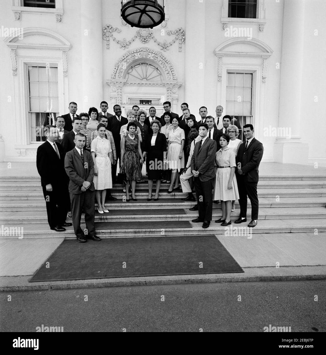 Director of the White House Summer Seminar Dorothy H. Davies with Seminar participants, and performers Tony Bennett and Eugene Wright. Participants in the White House Summer Seminar pose with singer Tony Bennett and bassist Eugene Wright following an American jazz concert sponsored by the Seminar the previous day. White House staff assistant and Summer Seminar Director, Dorothy H. Davies, stands at center. North Portico, White House, Washington, D.C. [Photograph by Harold Sellers] Stock Photo