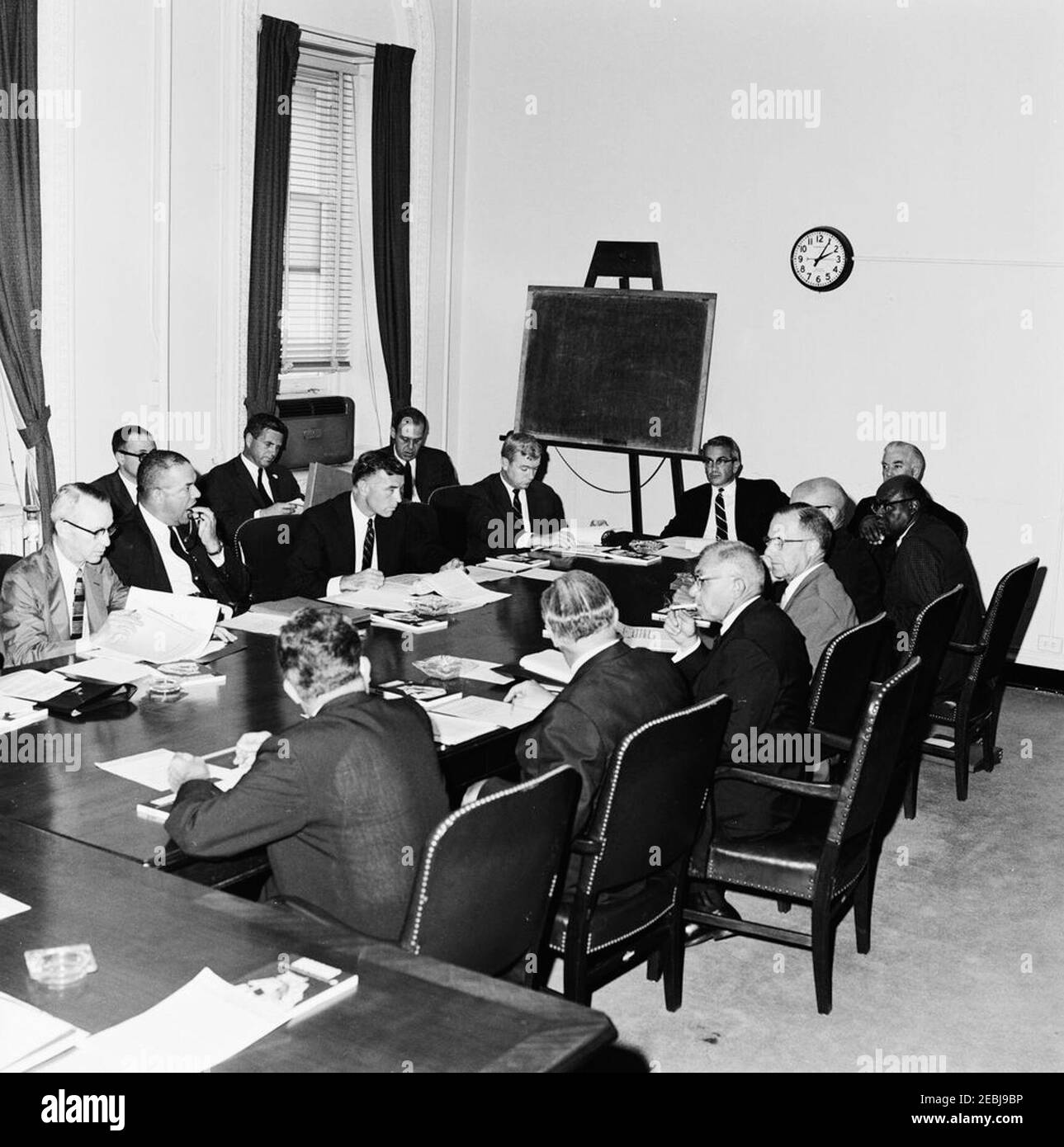 Meeting of the Presidentu0027s Commission on Equal Opportunity in Housing, Executive Office Building (EOB). Members of the Presidentu2019s Committee on Equal Opportunity in Housing meet in the Executive Office Building. Administrator for the Veterans Administration, General John S. Gleason, sits at far right, partially hidden. Washington D.C. Stock Photo