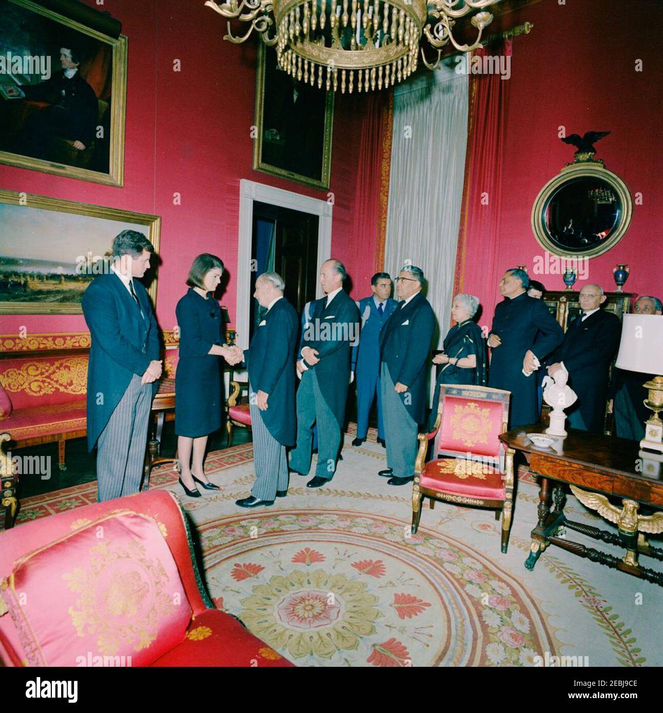 State Funeral of President Kennedy: White House, post funeral Reception. Jacqueline Kennedy and Senator Edward M. Kennedy (Massachusetts) greet guests during a reception at the White House, following the state funeral of President John F. Kennedy; Mrs. Kennedy shakes hands with Minister of Foreign Affairs of Mexico, Manuel Tello. Also pictured: Ambassador of Mexico, Antonio Carrillo Flores; Chief delegate to the United Nations (UN) from India, Vijaya Lakshmi Pandit; Ambassador of India, B. K. Nehru; Federal Councillor of Switzerland, Friedrich T. Wahlen; Secretary General of the Federal Politi Stock Photo