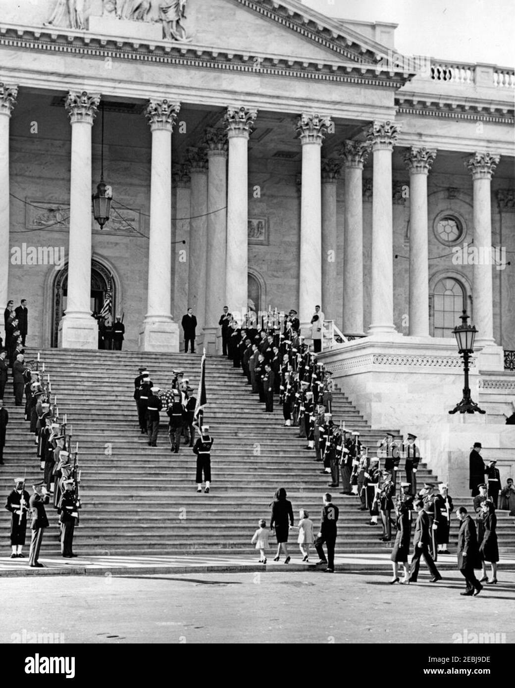 State Funeral of President Kennedy: Departure from the White House and Procession to the United States Capitol. Honor guard pallbearers carry the flag-draped casket of President John F. Kennedy up the steps of the Capitol Building, following a funeral procession from the White House. Jacqueline Kennedy walks in center with her children, Caroline Kennedy and John F. Kennedy, Jr., and Attorney General, Robert F. Kennedy. Walking behind Mrs. Kennedy: Jean Kennedy Smith; Steve Smith; Patricia Kennedy Lawford; and White House Secret Service agent, Clint Hill. Pallbearers include: Lance Corporal Jer Stock Photo