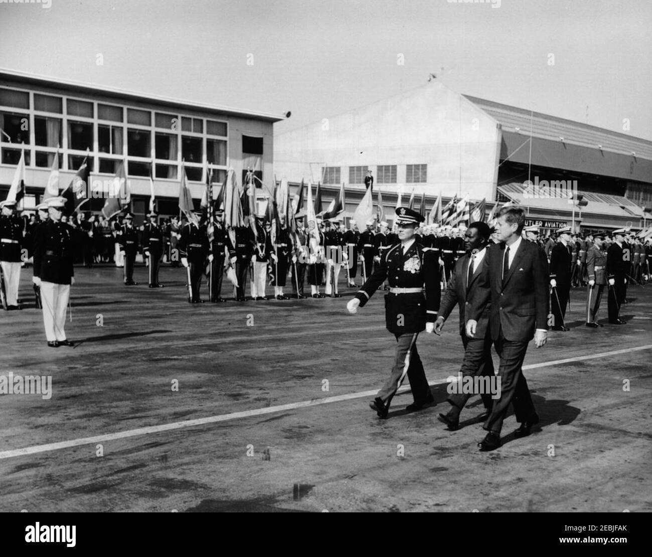 Arrival ceremony for Ahmed Su00e9kou Touru00e9, President of Guinea, 11:00AM. President John F. Kennedy and President of Guinea, Ahmed Su00e9kou Touru00e9, review honor guard troops during arrival ceremonies for President Touru00e9; an unidentified Commander of Troops walks left of the Presidents. Military Air Transport Service (MATS) terminal, Washington National Airport, Washington D.C. Stock Photo