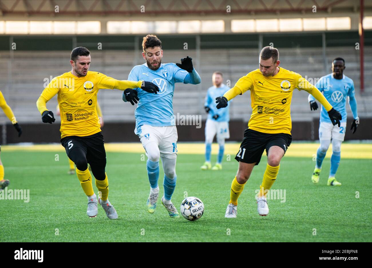 Malmoe, Sweden. 12th Feb, 2021. Erdal Rakip (19) of Malmoe FF seen in between Kadir Hodzic (5) and Adam Petersson (21) of Mjallby during a test match between Malmoe FF and Mjallby AIF at Malmoe Idrottsplats in Malmoe. (Photo Credit: Gonzales Photo/Alamy Live News Stock Photo