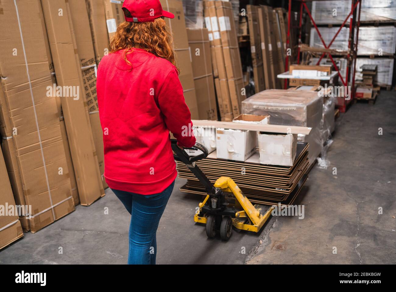 Female worker using a pallet jack at a warehouse Stock Photo Alamy