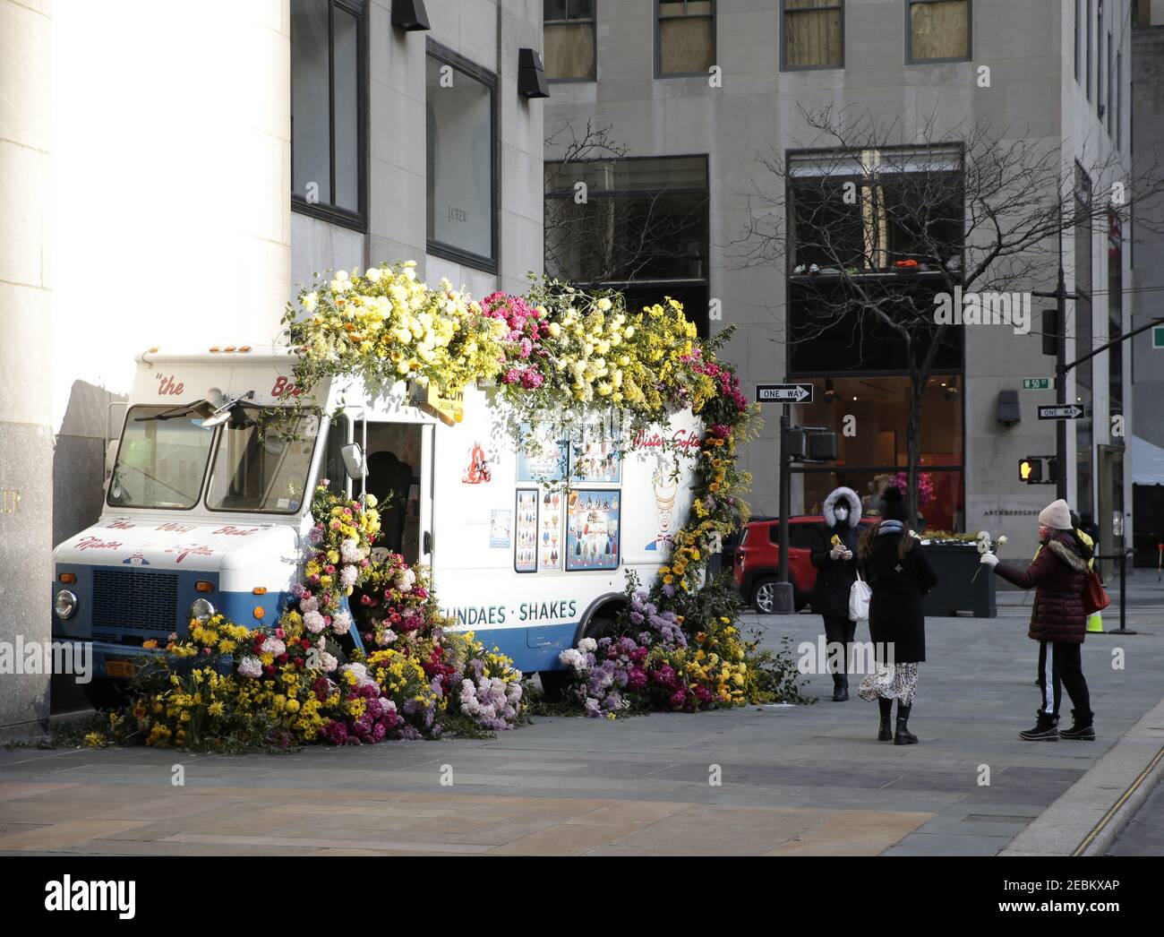 New York, United States. 12th Feb, 2021. Pedestrians walk by a Mister Softee ice cream truck covered in flowers in celebration of the upcoming Valentine's Day holiday at Rockefeller Center in New York City on Friday, February 12, 2021. In celebration of Valentine's Day, and as part of Rockefeller Center's month of 'Love at the Center,' renowned floral designer Lewis Miller Design put on display two custom-made Mister Softee trucks cascading with thousands of multi-colored roses, hydrangeas, daffodils, chrysanthemums, mimosas, and more. Photo by John Angelillo/UPI Credit: UPI/Alamy Live News Stock Photo