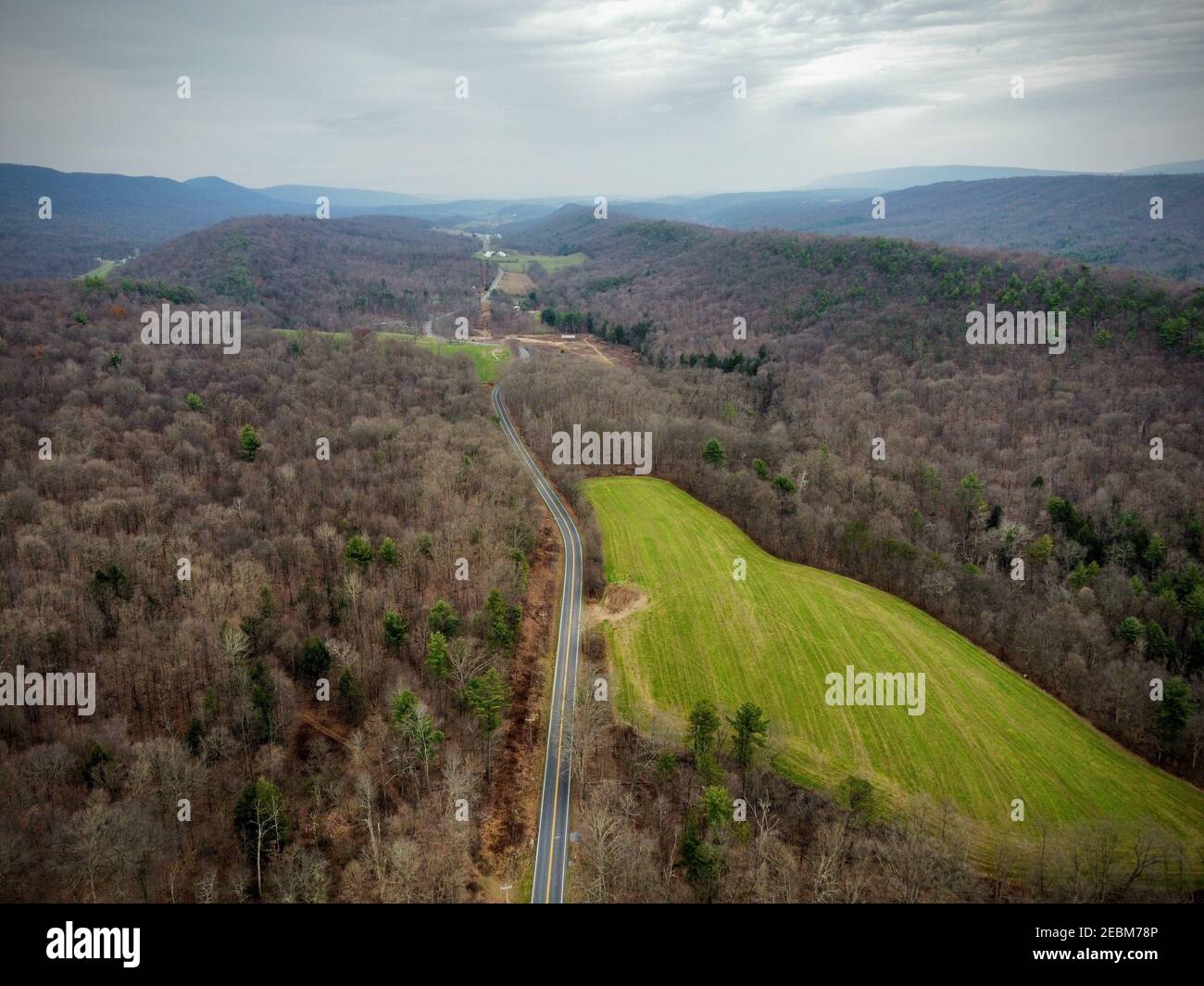 Aerial shot of valleys and trees under a foggy sky Stock Photo - Alamy