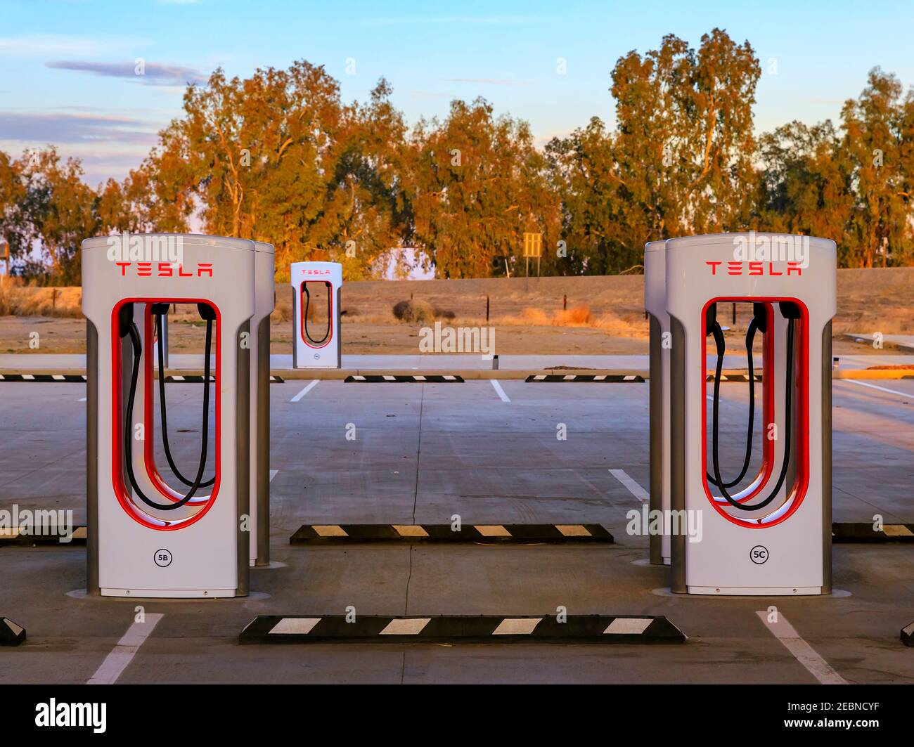 Firebaugh, USA - January 21, 2021: Rows of empty electric Tesla superchargers by California Highway 5 Stock Photo