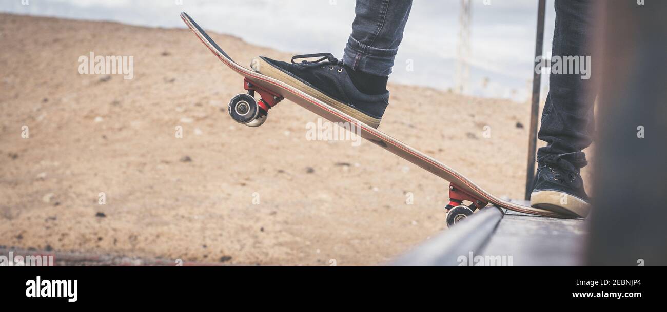 Close up view of teen's feet on a skateboard ready to start a ride over the