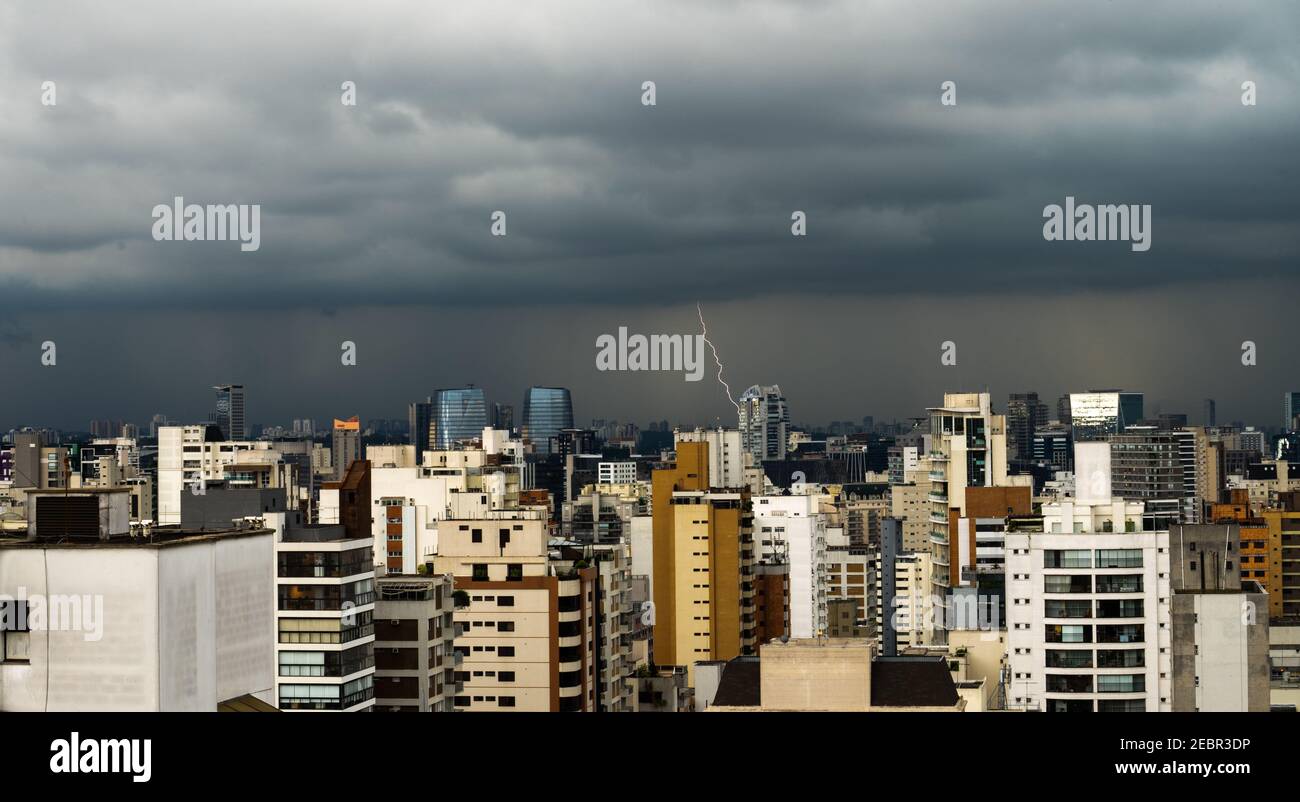 City Skyline of an afternoon lightning storm with multiple lightning bolts over the Vila Olimpia and Chacara Itaim neighboor in Sao Paulo, Brazil Stock Photo
