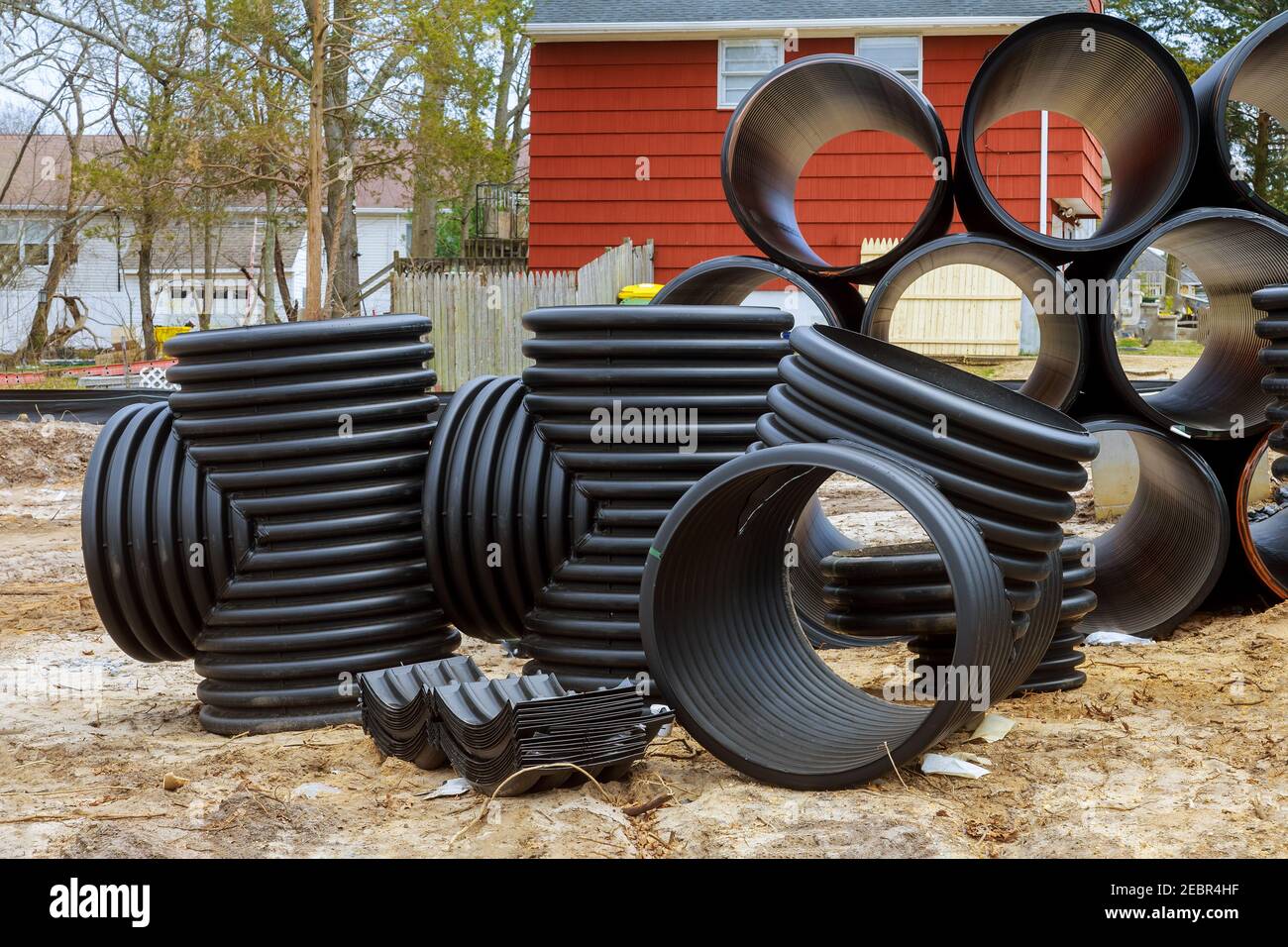 Plastic PVC pipes stacked in rows at construction site on ...