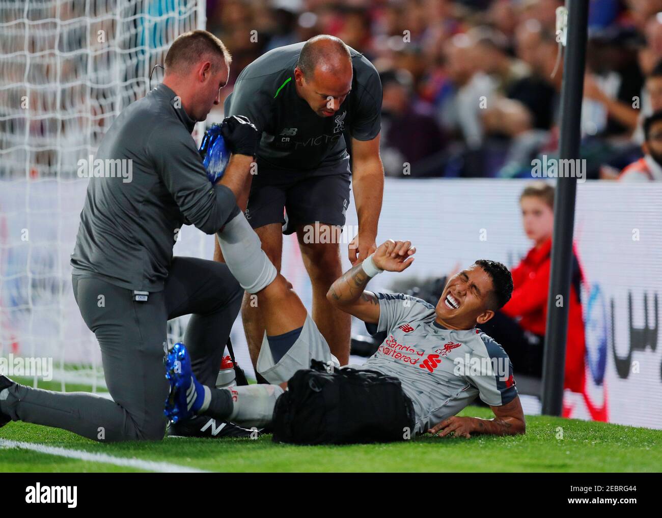 Soccer Football - Premier League - Crystal Palace v Liverpool - Selhurst Park, London, Britain - August 20, 2018  Liverpool's Roberto Firmino receives medical attention after sustaining an injury                      REUTERS/Eddie Keogh  EDITORIAL USE ONLY. No use with unauthorized audio, video, data, fixture lists, club/league logos or 'live' services. Online in-match use limited to 75 images, no video emulation. No use in betting, games or single club/league/player publications.  Please contact your account representative for further details. Stock Photo