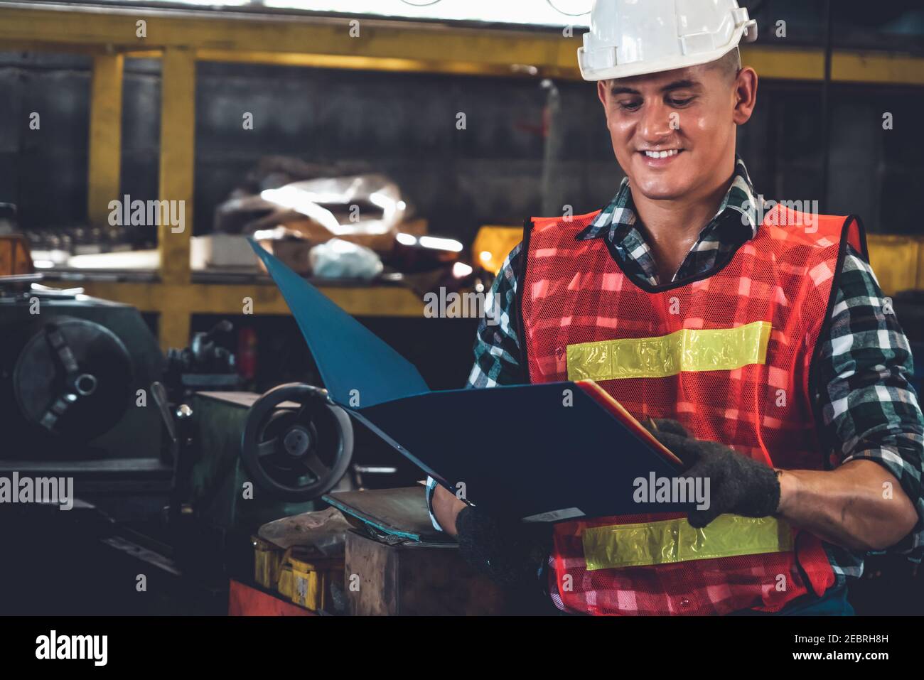 Manufacturing worker working with clipboard to do job procedure