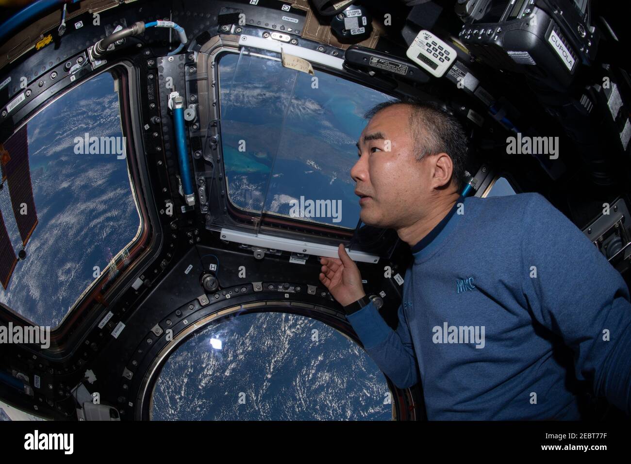 JAXA Astronaut and Expedition 64 Flight Engineer Soichi Noguchi, enjoys the view of Earth below from the seven-windowed cupola 260 miles above the Caribbean Sea aboard the International Space Station January 21, 2021 in Earth Orbit. Stock Photo