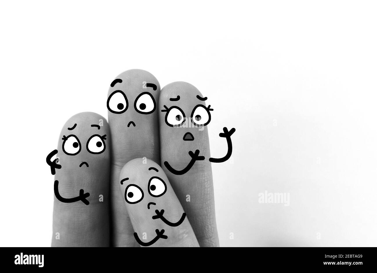 Four fingers are decorated as four person. They are worried. Stock Photo