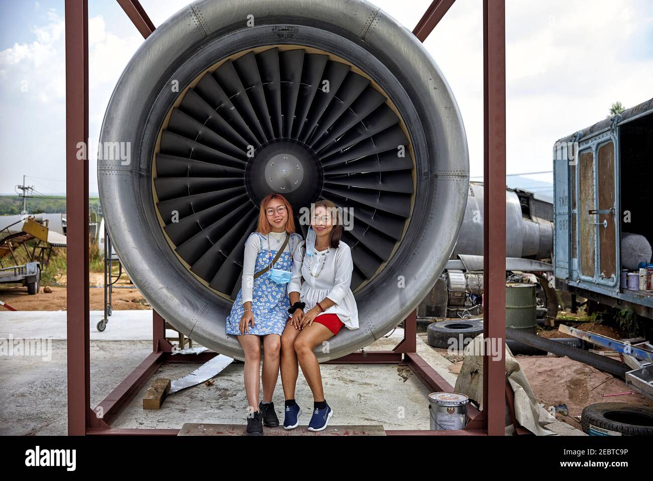 People sat inside a jet turbine engine providing human size comparison Stock Photo