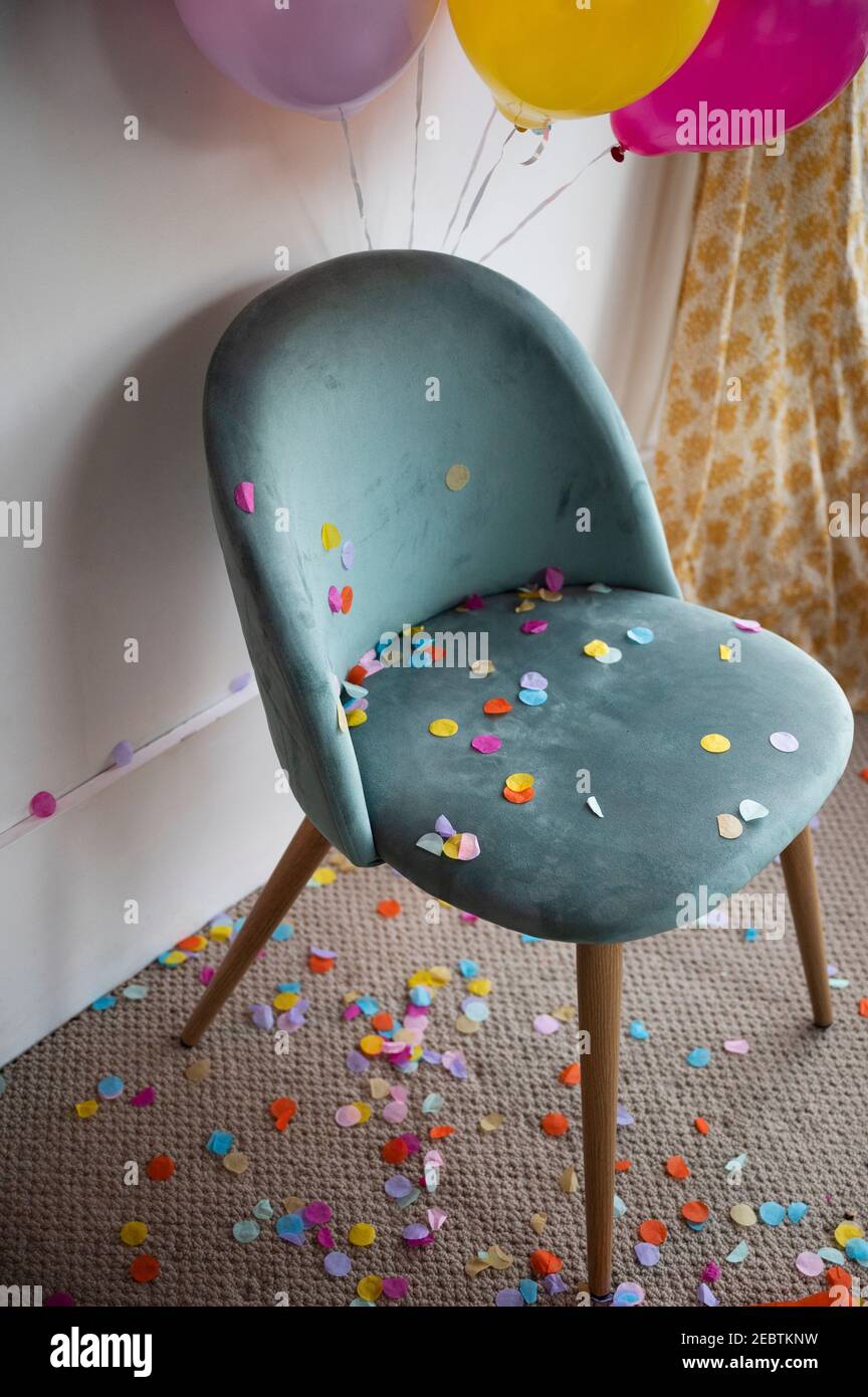 Confetti and balloons in room Stock Photo