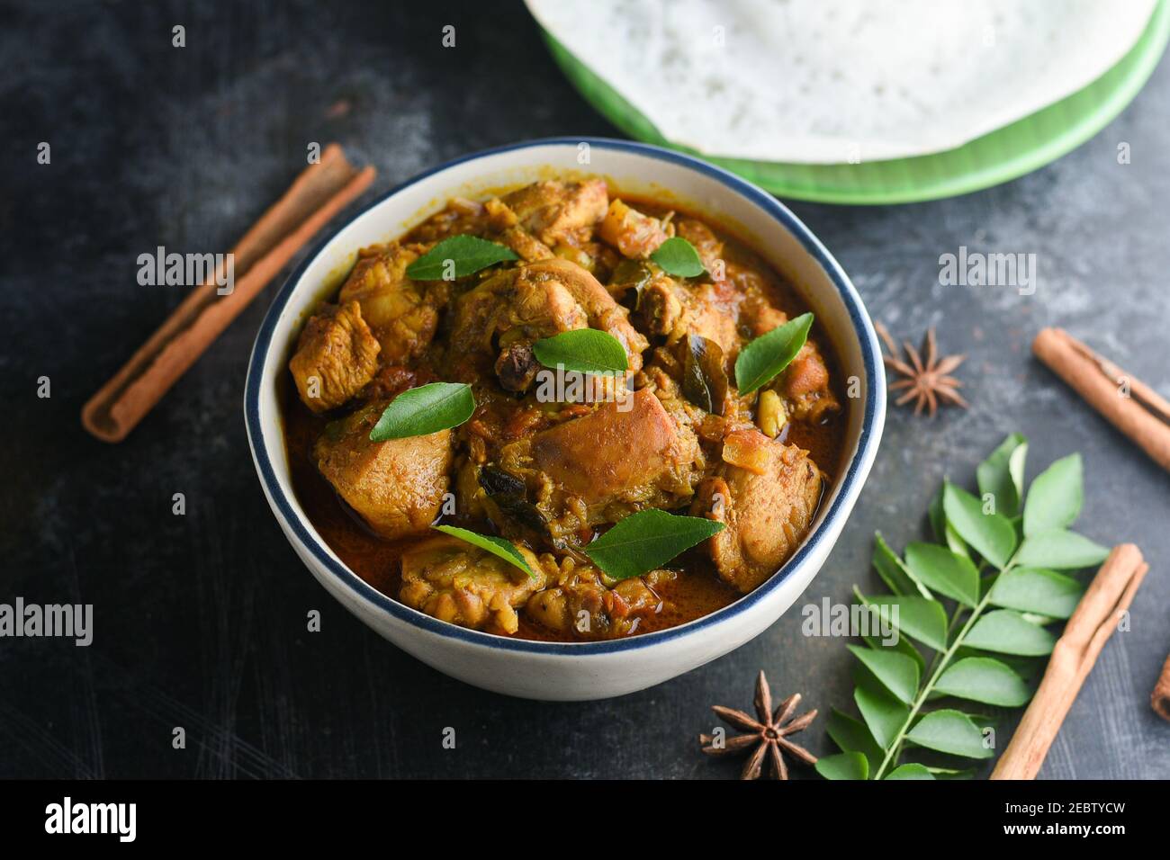 Masala Chicken curry with Appam Kerala breakfast , Hoppers pan cake , homemade chicken roast Indian spices , Asian cuisine spicy meat curry cooked Stock Photo