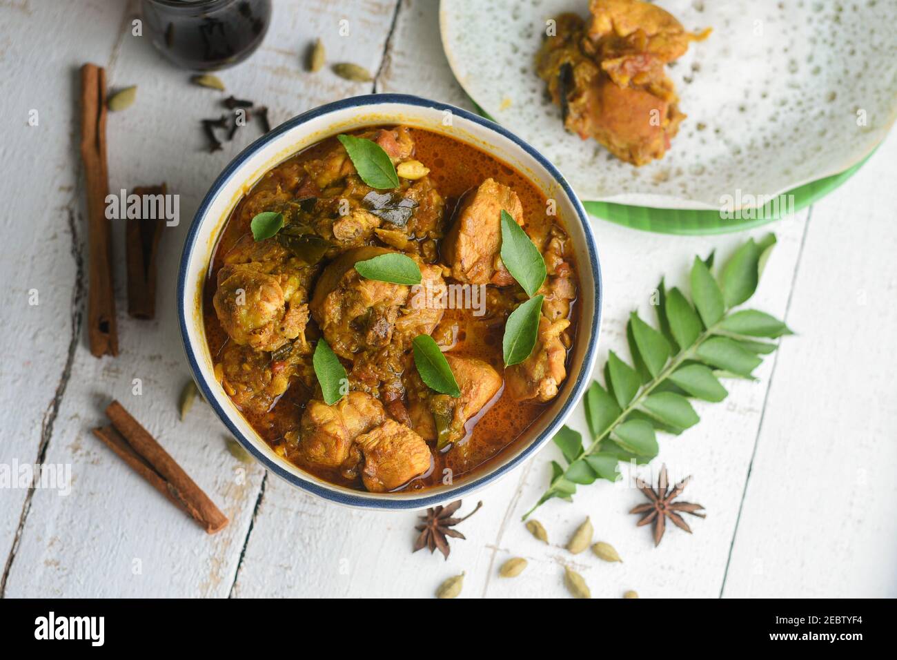 Masala Chicken curry with Appam Kerala breakfast , Hoppers pan cake , homemade chicken roast Indian spices , Asian cuisine spicy meat curry cooked Stock Photo