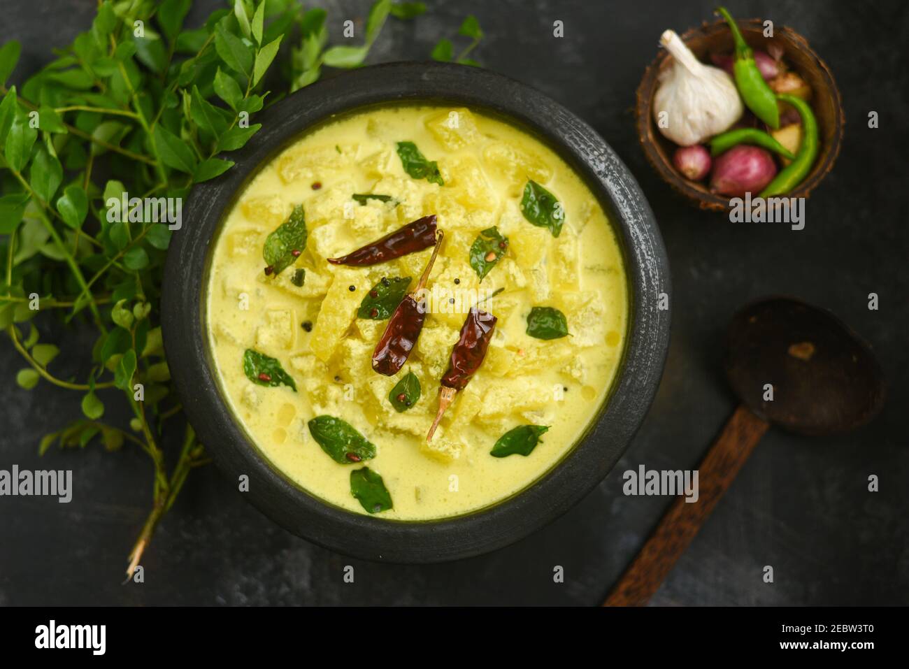 Bowl of homemade sour cream curd yogurt Dahi fresh herbs curry leaf