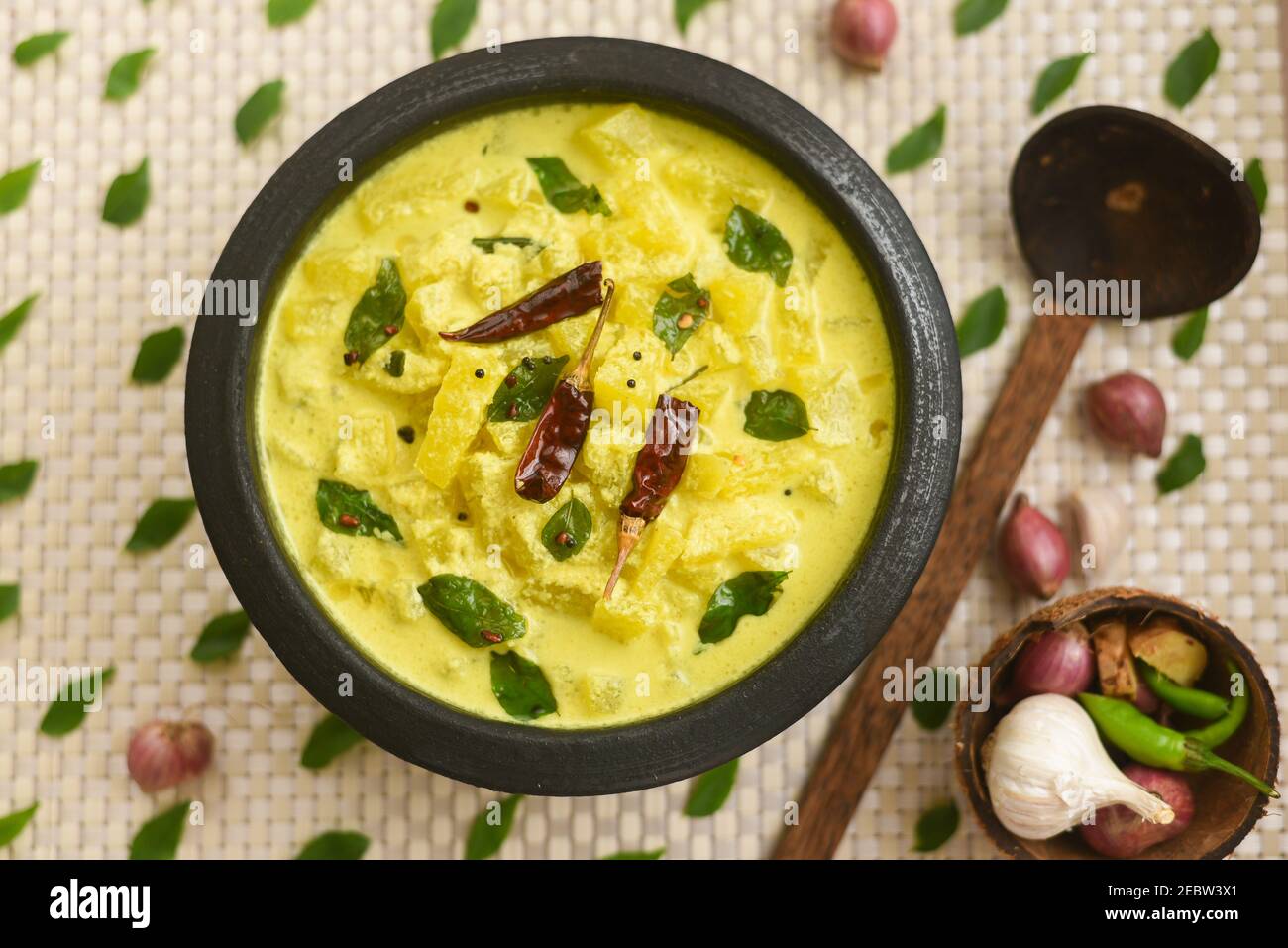 Bowl of homemade sour cream curd yogurt Dahi fresh herbs curry leaf