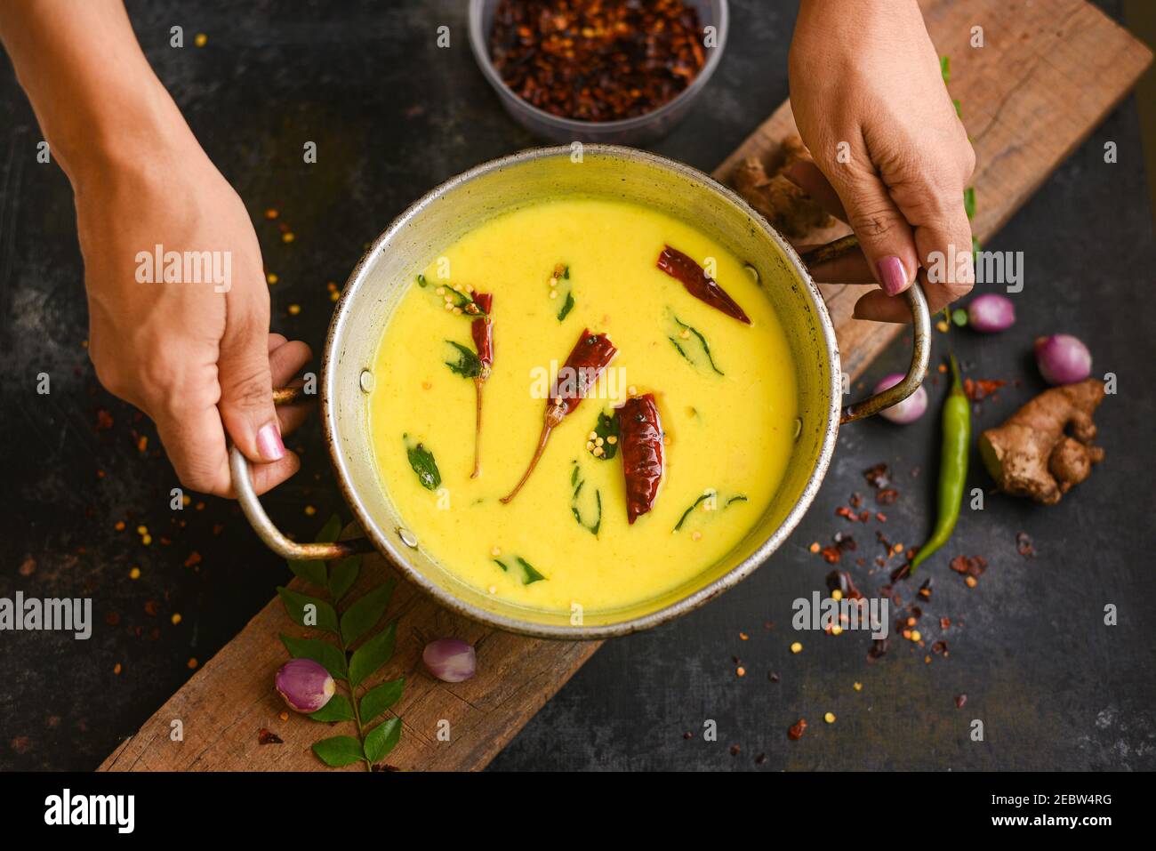 Bowl of homemade sour cream curd yogurt Dahi fresh herbs curry leaf