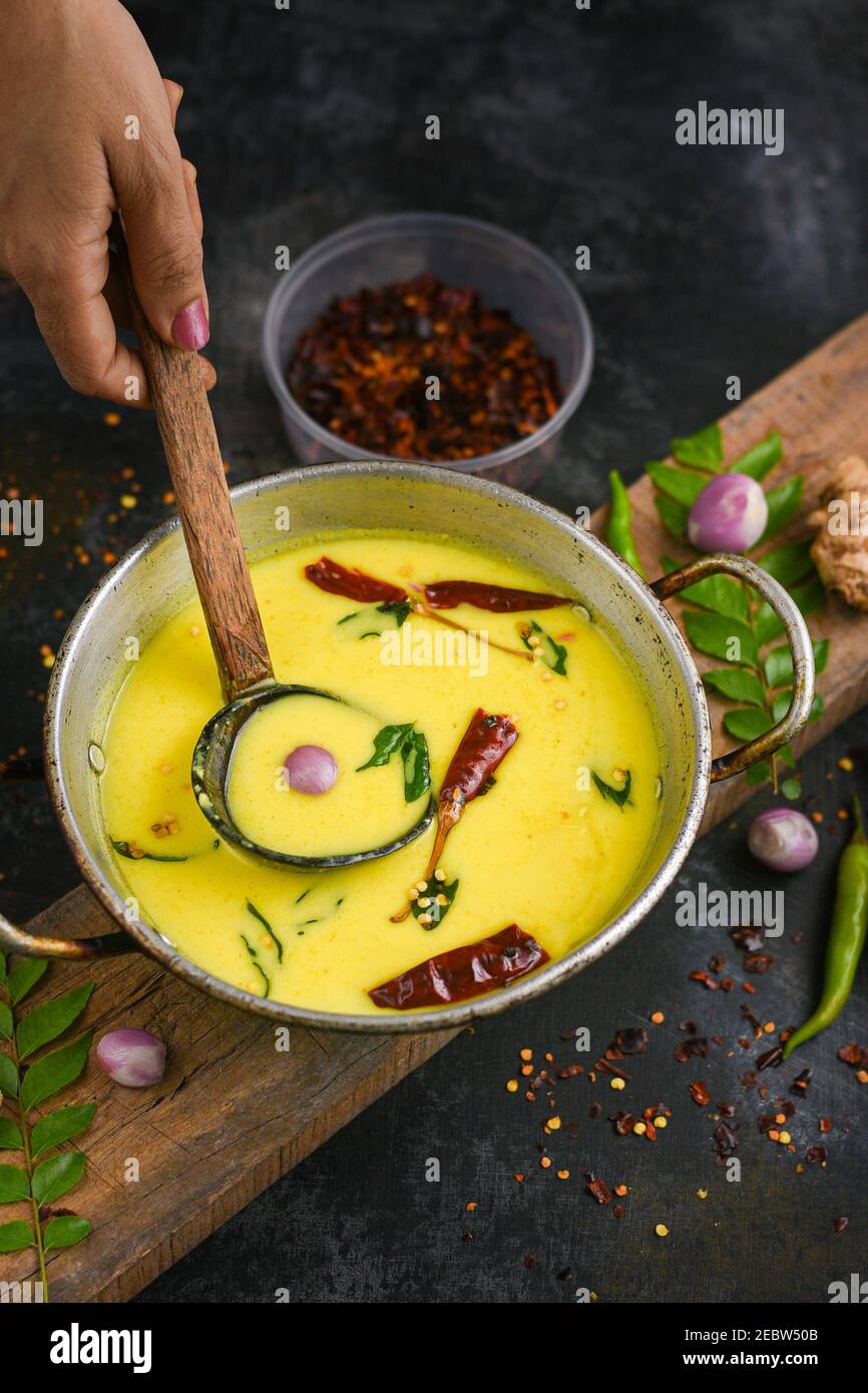 Bowl of homemade sour cream curd yogurt Dahi fresh herbs curry leaf
