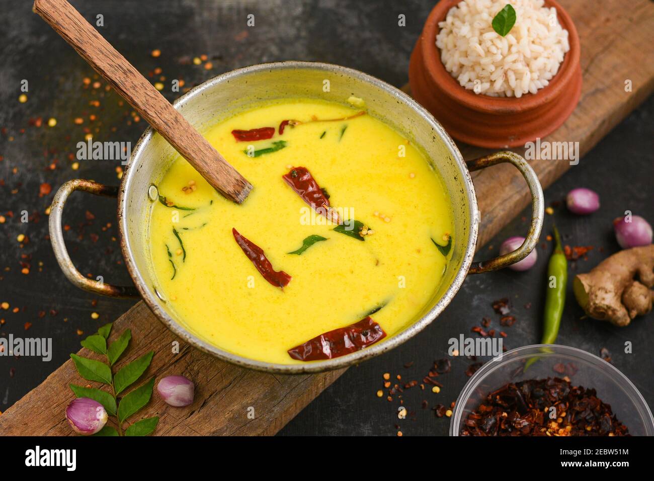 Bowl of homemade sour cream curd yogurt Dahi fresh herbs curry leaf Kerala, India. Dairy product