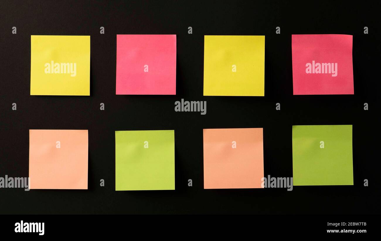 lots of colored stickers on a black background. stickers on the wall