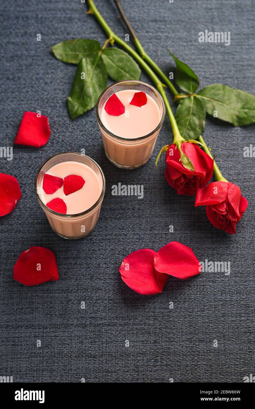 Rose milk , Rose shake , Gulab Shake with rose petals Indian valentines day  drink with heart shaped red rose flowers Kerala. strawberry milk shake  Stock Photo - Alamy