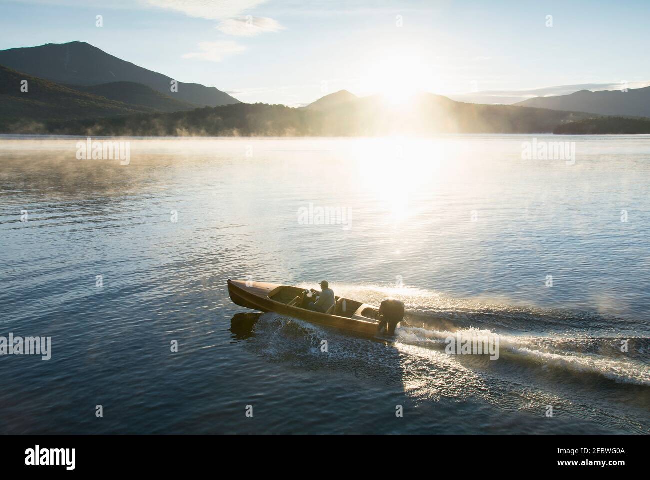 USA, New York, Lake Placid, Man in motorboat on Lake Placid Stock Photo
