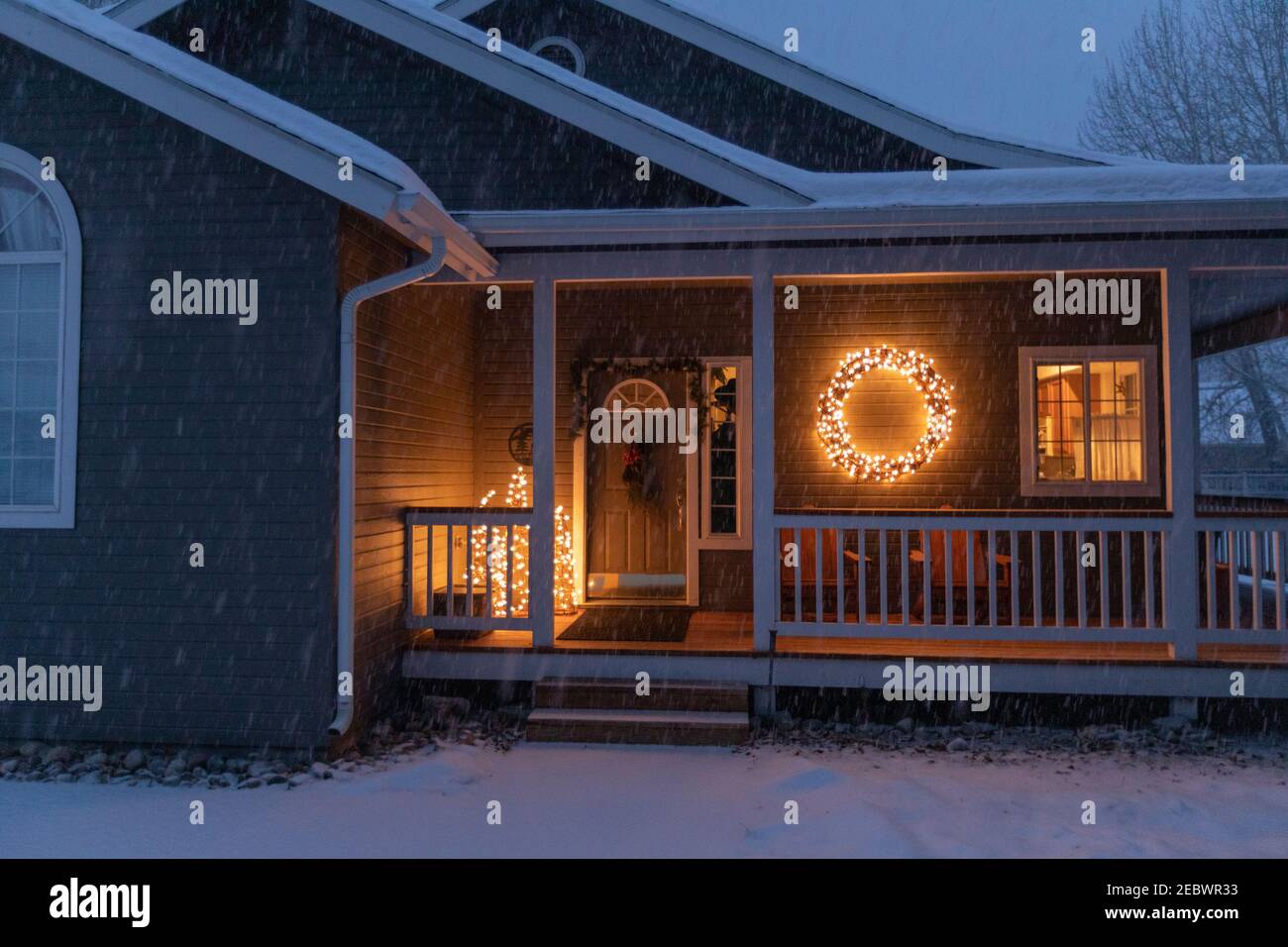 USA, Idaho, Bellevue, Porch decorated with Christmas lights during snow storm Stock Photo