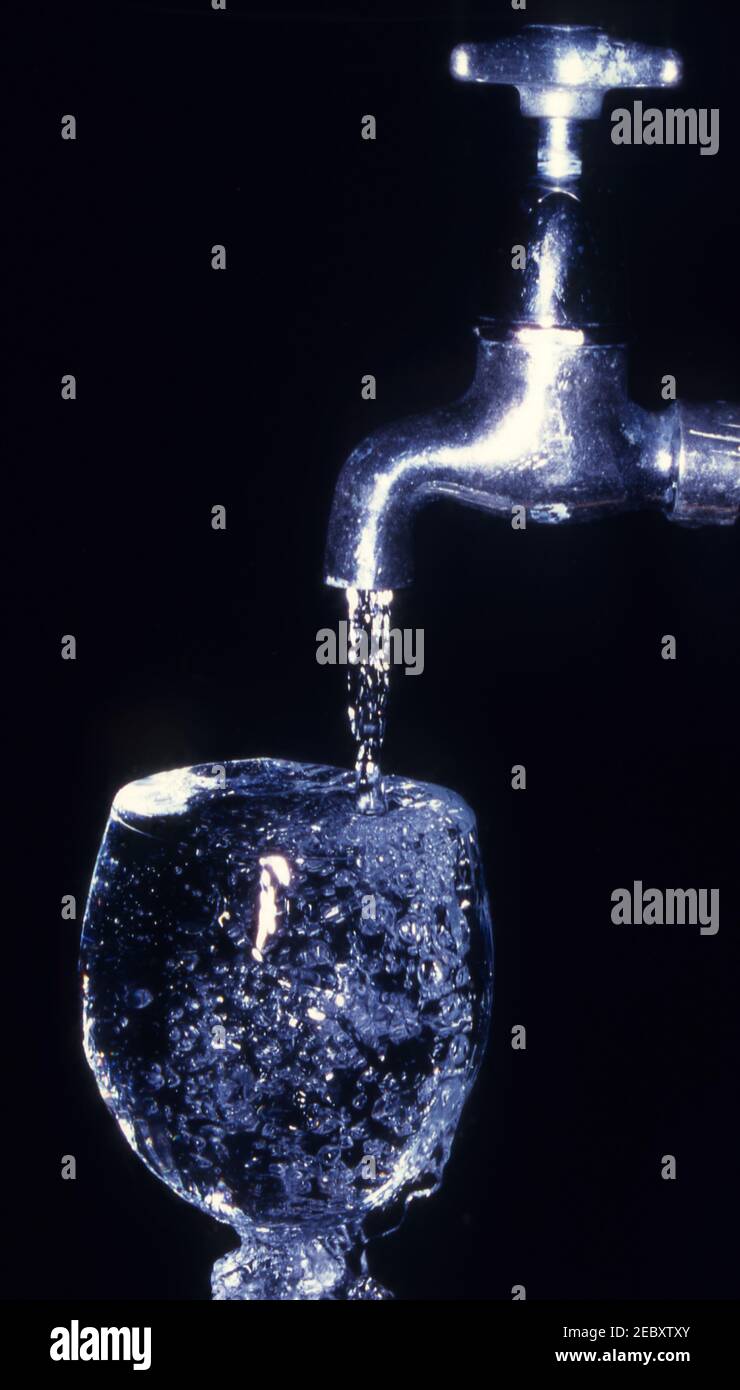 WATER FROM OLD FASHIONED SILVER TAP RUNNING INTO A WINE GLASS Stock Photo Alamy
