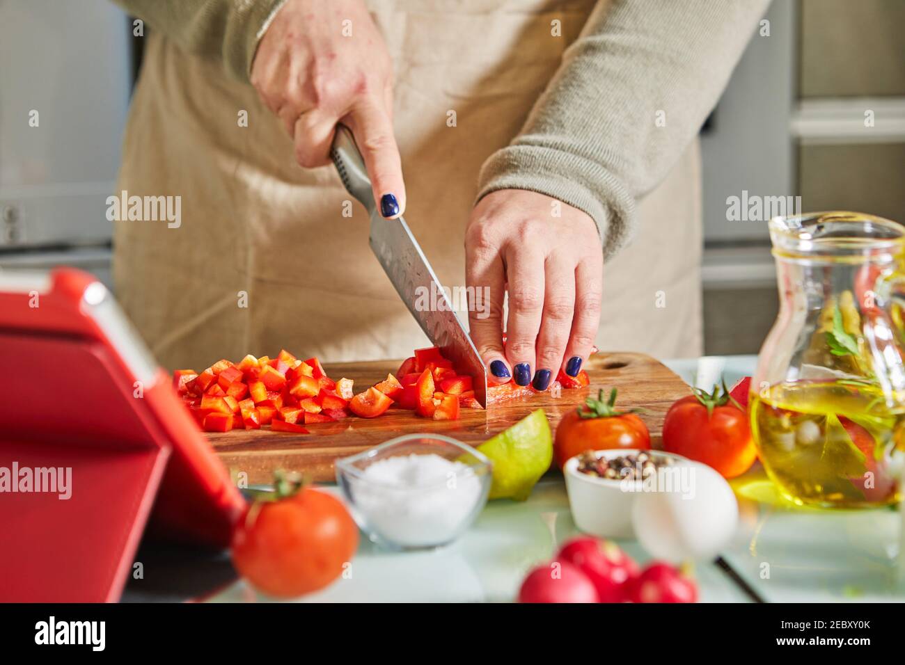 Woman cooking according the tutorial of online virtual master class ...