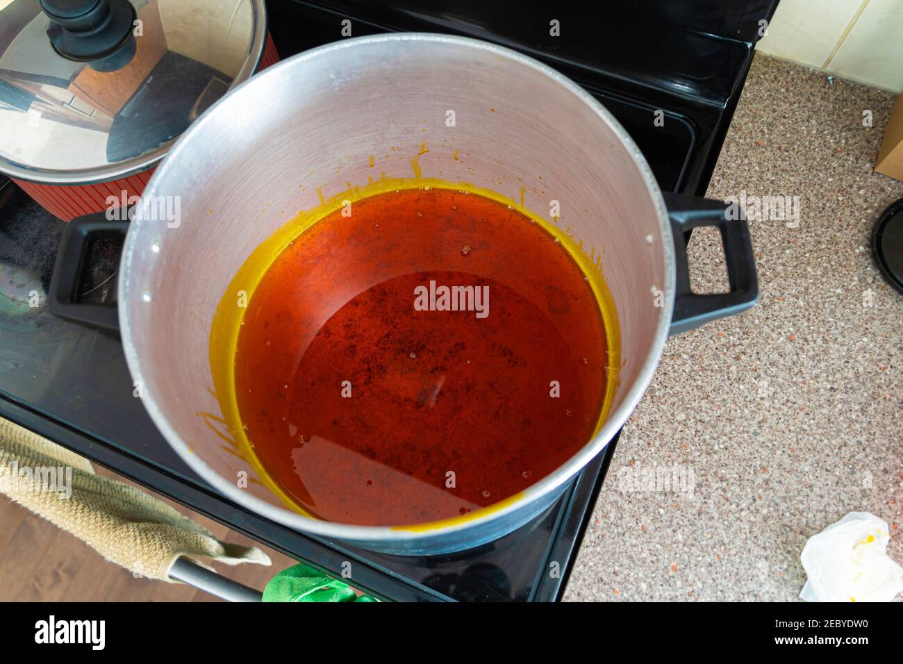 Palm oil warming up melting in pot to prepare Egusi Vegetable soup