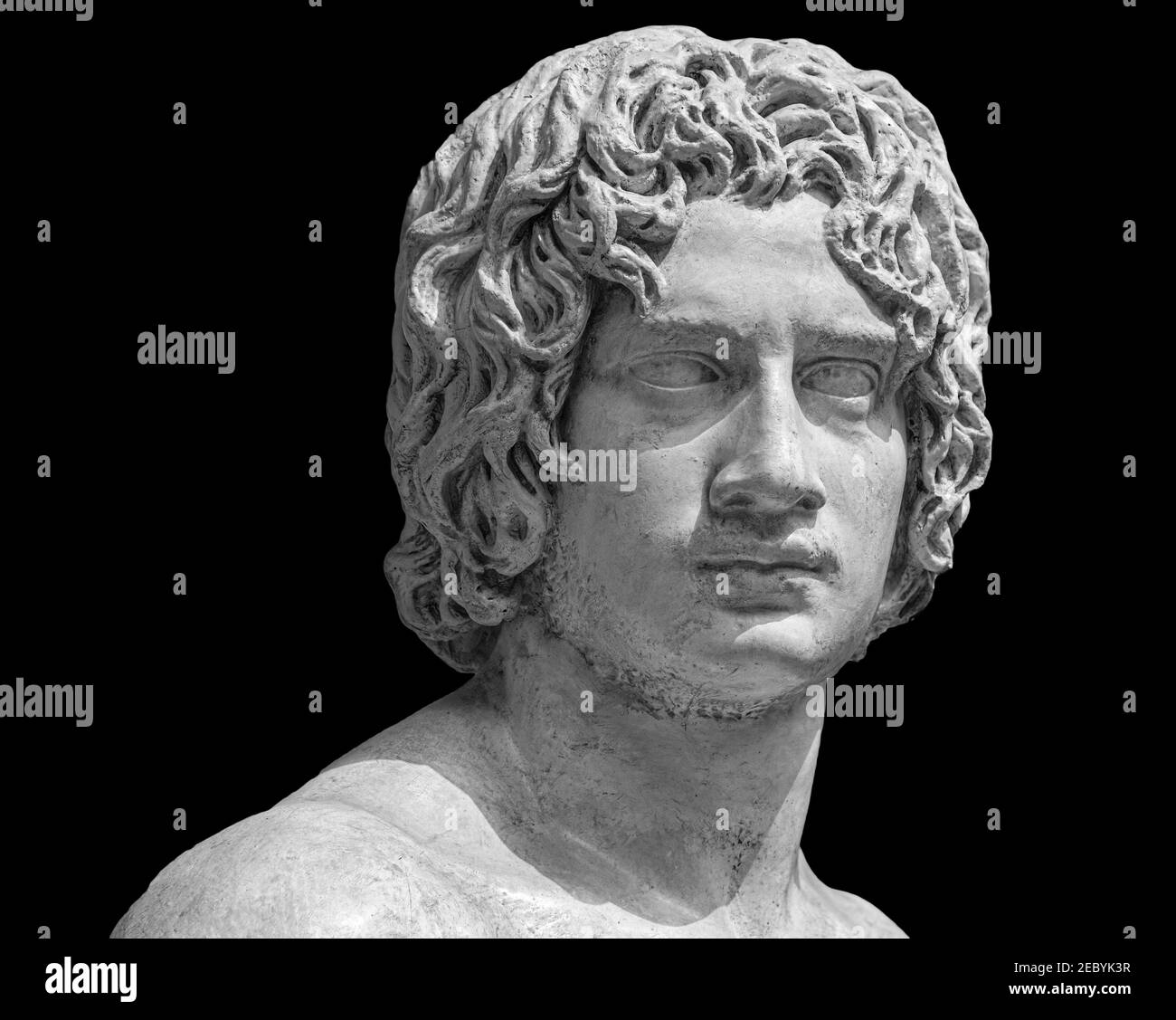 Ancient roman marble portrait of a boy. Young man head statue isolated on black background. Antique sculpture Stock Photo
