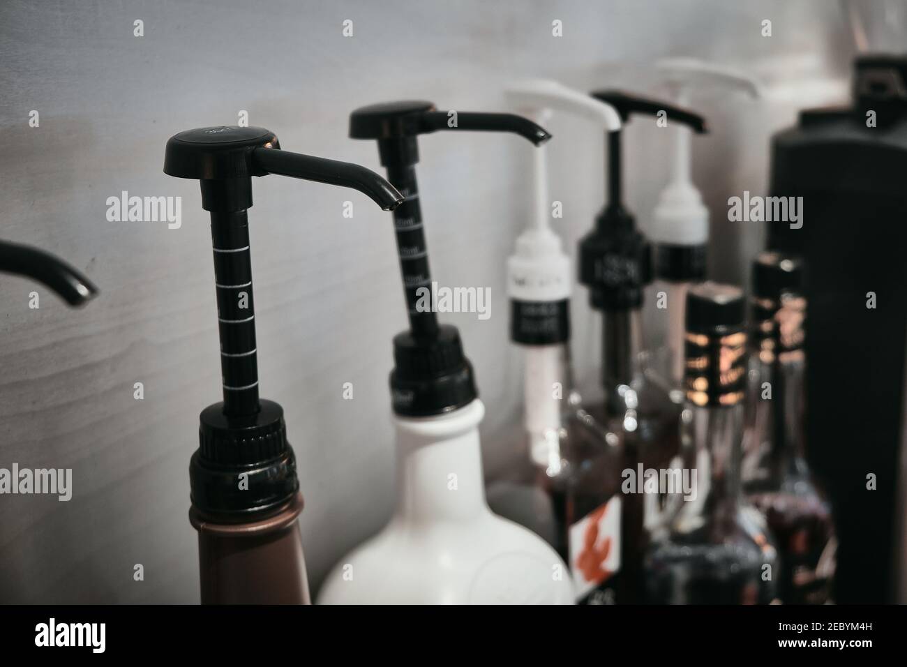 Row Of Coffee Flavoring Syrup Bottles With Dispenser Stock Photo Alamy