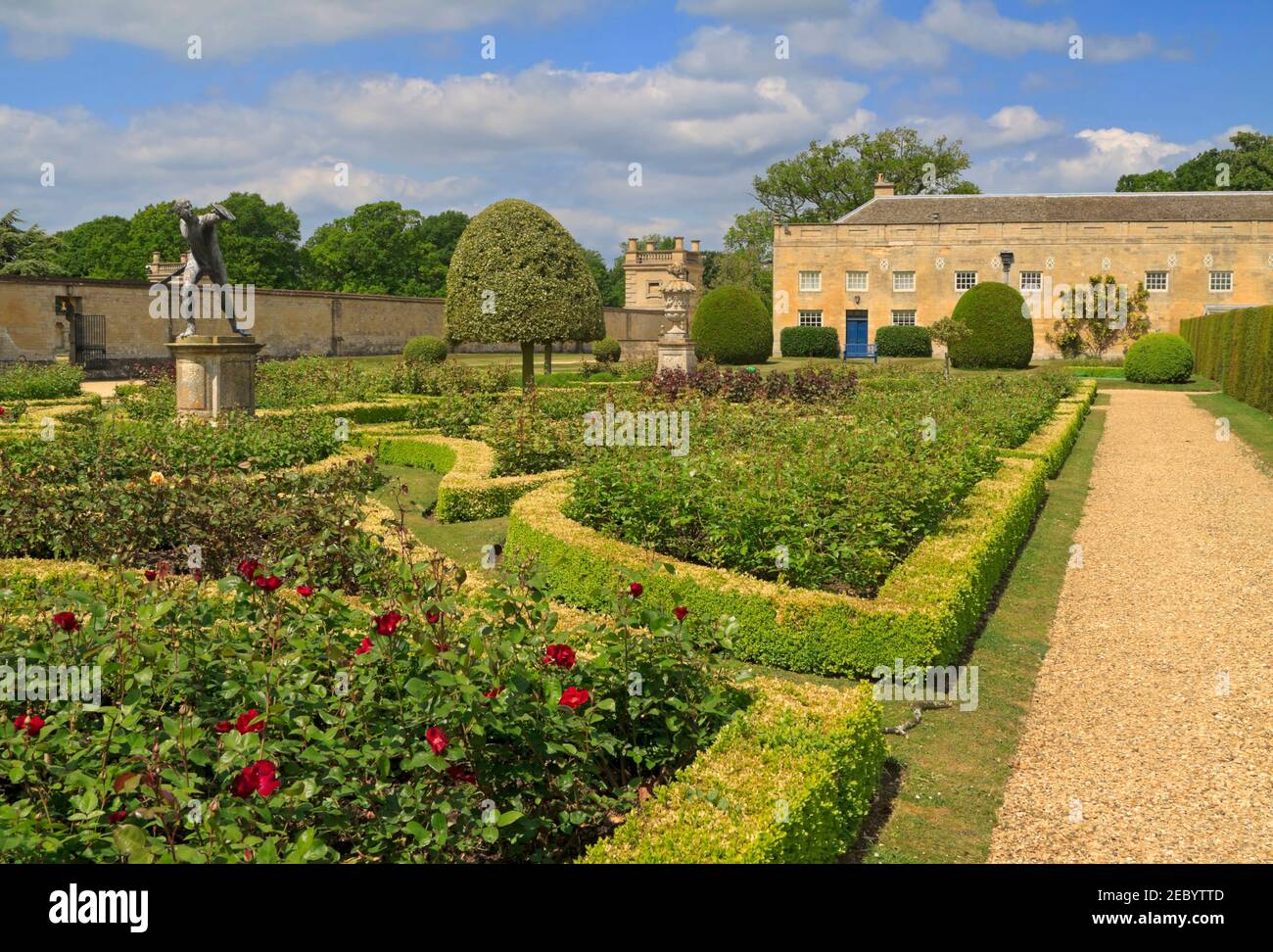 Grimsthorpe Castle, Bourne, Lincolnshire. Rose parterre garden with formal box hedges and statue of a gladiator. Stock Photo