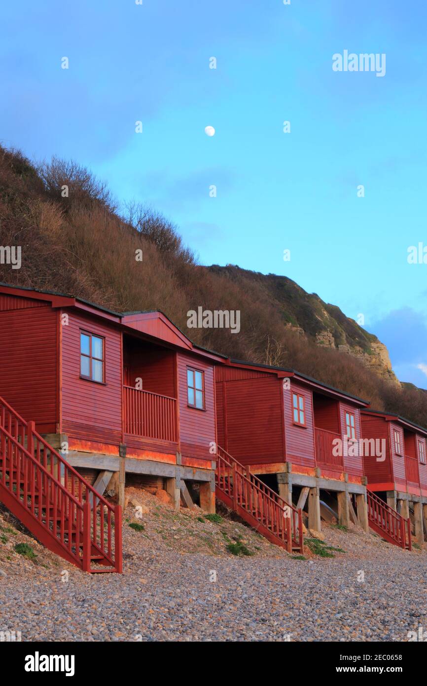 Red beach huts in village of Branscombe, Devon on the Jurassic Coast Stock Photo