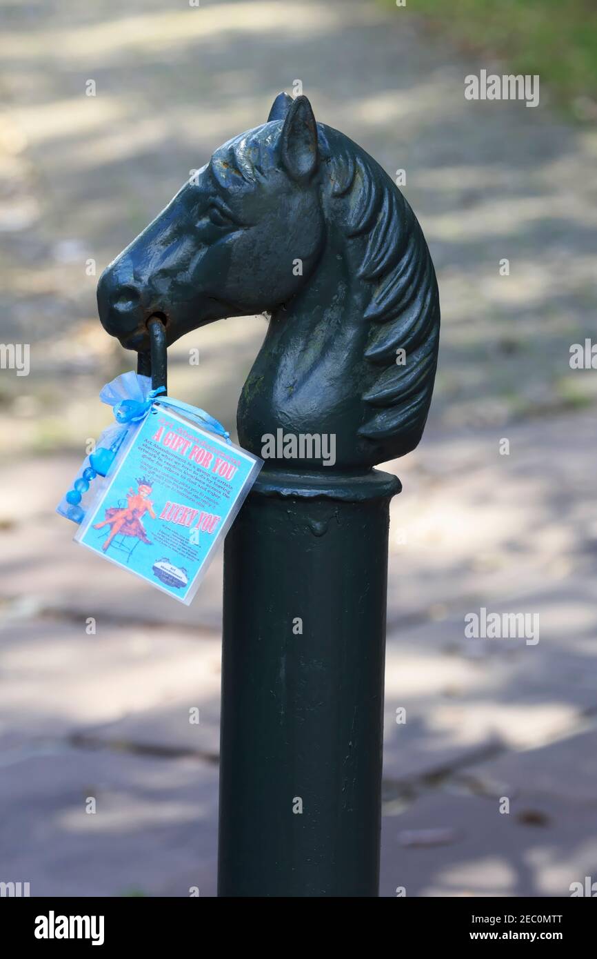 Hitching post with Mardi Gras gift, Garden District, New Orleans Stock Photo