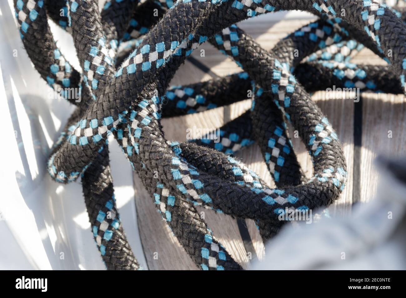 Close up of striped sheet on wooden seat of a sailboat's deck. Selective focus. Copy space. Stock Photo