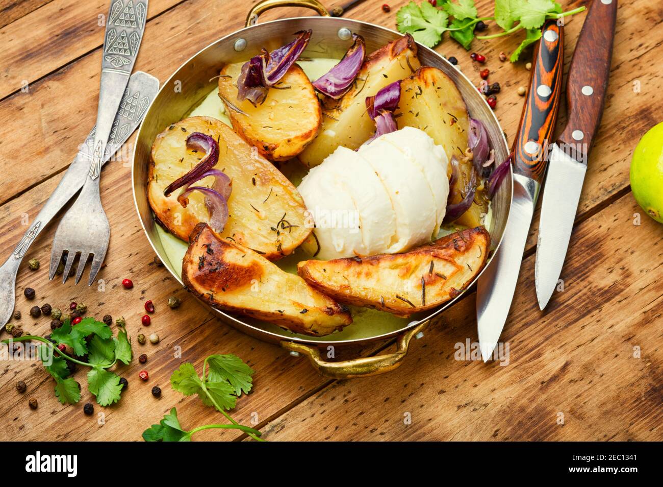 Homemade baked potatoes with mozzarella cheese and onions Stock Photo
