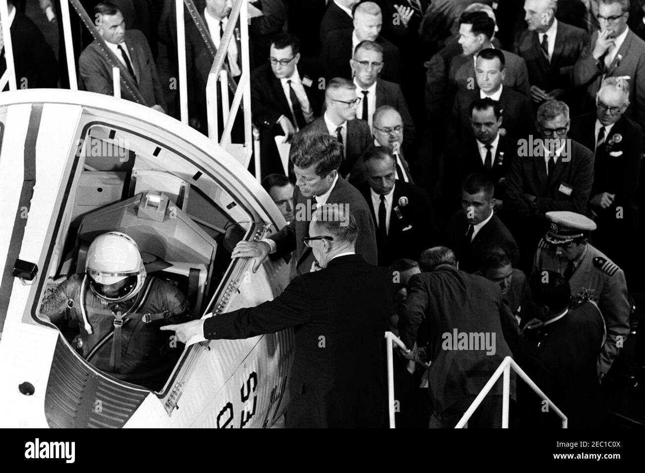 Inspection tour of NASA installations: St. Louis, Missouri, McDonnell Aircraft, 3:27PM. President John F. Kennedy views a mock-up of the Gemini space capsule, during a tour of the McDonnell Aircraft Corporation plant in St. Louis, Missouri. Vice President of the McDonnell Aircraft Corporation and General Manager of Projects Mercury and Gemini, Walter F. Burke (gesturing with hand), briefs President Kennedy; McDonnell engineer, Elbert Wiegand, sits in cockpit of the two-man spacecraft. Also pictured: Chairman of the Board and Chief Executive Officer of the McDonnell Aircraft Corporation, James Stock Photo