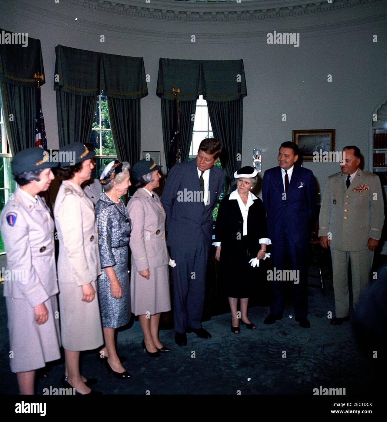 Visit of representatives of the Womenu0027s Army Corps regarding 20th Anniversary, Oval Office, 11:45AM. President John F. Kennedy visits with representatives of the Womenu2019s Army Corps (WAC) regarding the corpsu2019 20th anniversary. Left to right: Director-designate of the WAC, Lieutenant Colonel Emily C. Gorman; former WAC director, Colonel Irene O. Galloway; former WAC director, Colonel Westray Battle Leslie; Director of the WAC, Colonel Mary Louise Milligan Rasmuson; President Kennedy; former WAC director, Colonel Mary Hallaren; Secretary of the Army, Elvis J. Stahr, Jr.; Chief of S Stock Photo