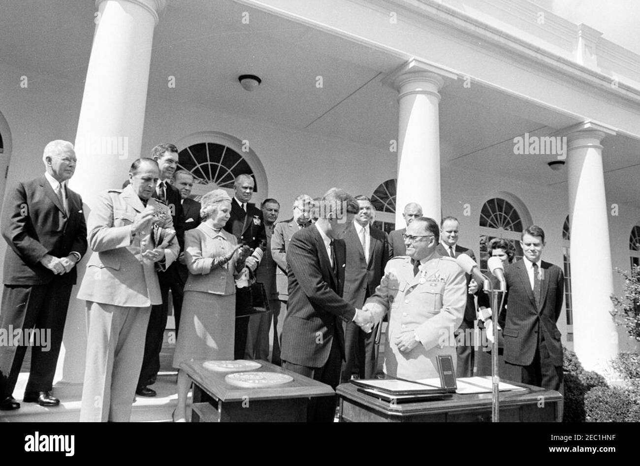 Presentation of the Distinguished Service Medal to Gen. George H. Decker, 12:05PM. President John F. Kennedy shakes hands with retiring Chief of Staff of the United States Army, General George H. Decker (center right), after presenting him with the Distinguished Service Medal (DSM). Standing in back (L-R): Director of the Central Intelligence Agency (CIA), John McCone; Chairman of the Joint Chiefs of Staff, General Lyman L. Lemnitzer; Representative George H. Mahon (Texas); Deputy Secretary of Defense, Roswell L. Gilpatric; Helen Decker; Chief of Naval Operations, Admiral George W. Anderson, J Stock Photo