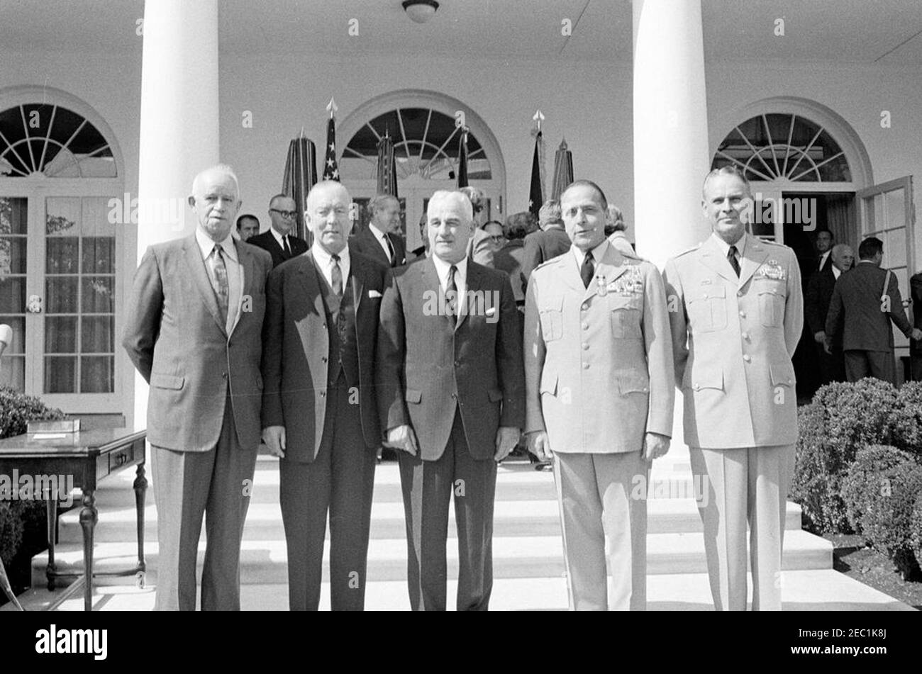 Swearing-in ceremony, Gen. Maxwell Taylor, Chairman, JCS, 12:00PM. Newly-appointed Chairman of the Joint Chiefs of Staff (JCS), General Maxwell D. Taylor, stands with former Chairmen of the JCS during his swearing-in ceremony. Left to right (in foreground): General Omar Bradley; Admiral Arthur W. Radford; General Nathan F. Twining; General Lyman L. Lemnitzer; General Taylor. Also pictured, in the background: Naval Aide to the President, Captain Tazewell T. Shepard, Jr.; Secretary of the Navy, Fred Korth; Deputy Secretary of Defense, Roswell Gilpatric; former Chief of Staff of the United States Stock Photo